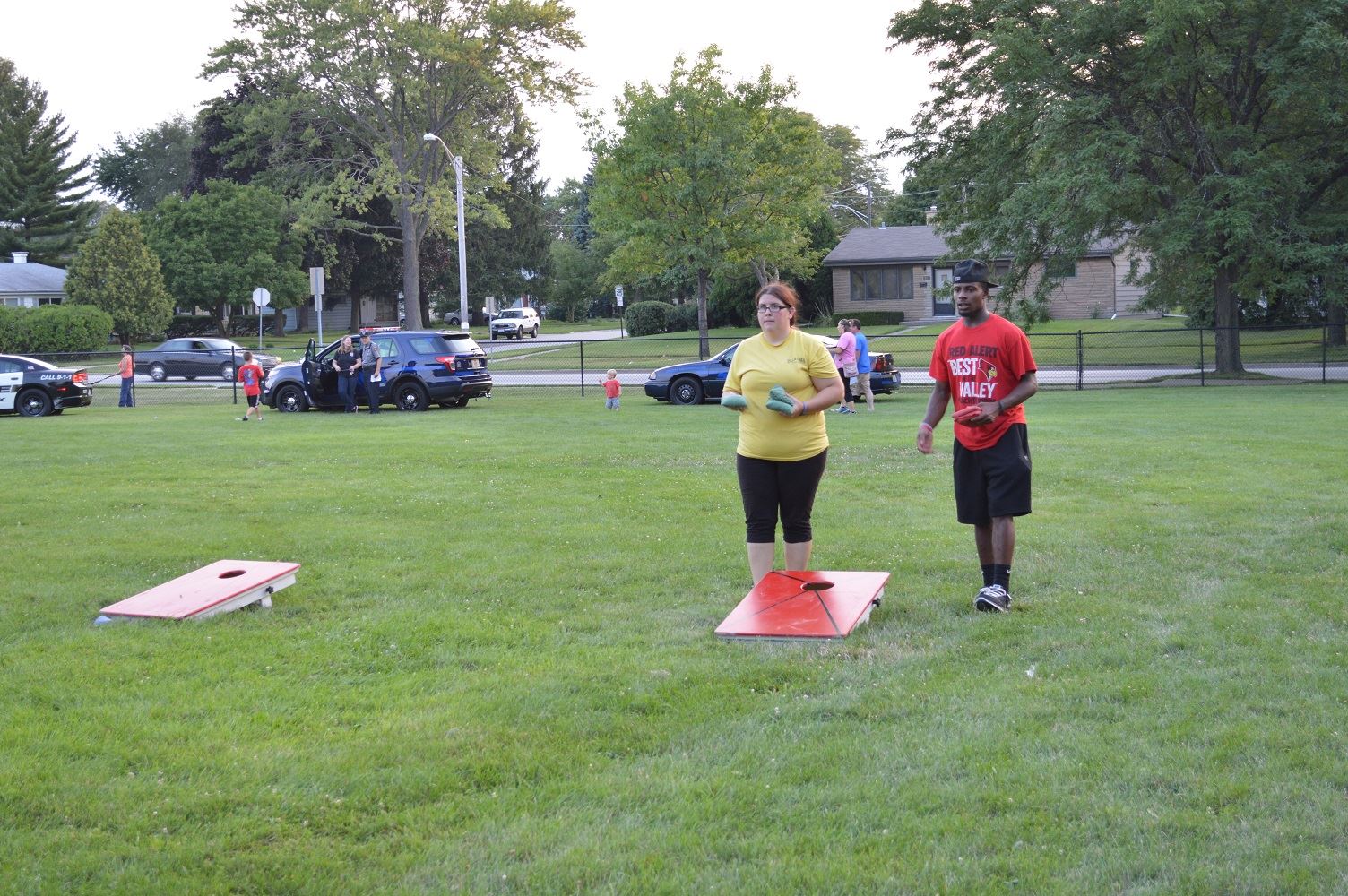 Community members play a game of bags at a National Night Out event at the Iowa Community Center, Aug. 2.